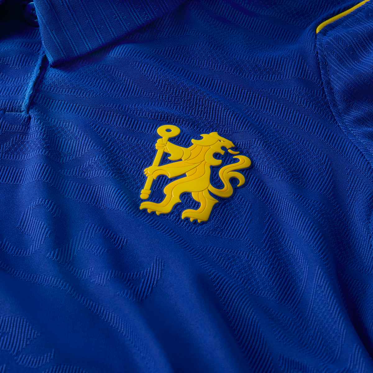 Close-up of a blue garment with a yellow lion emblem